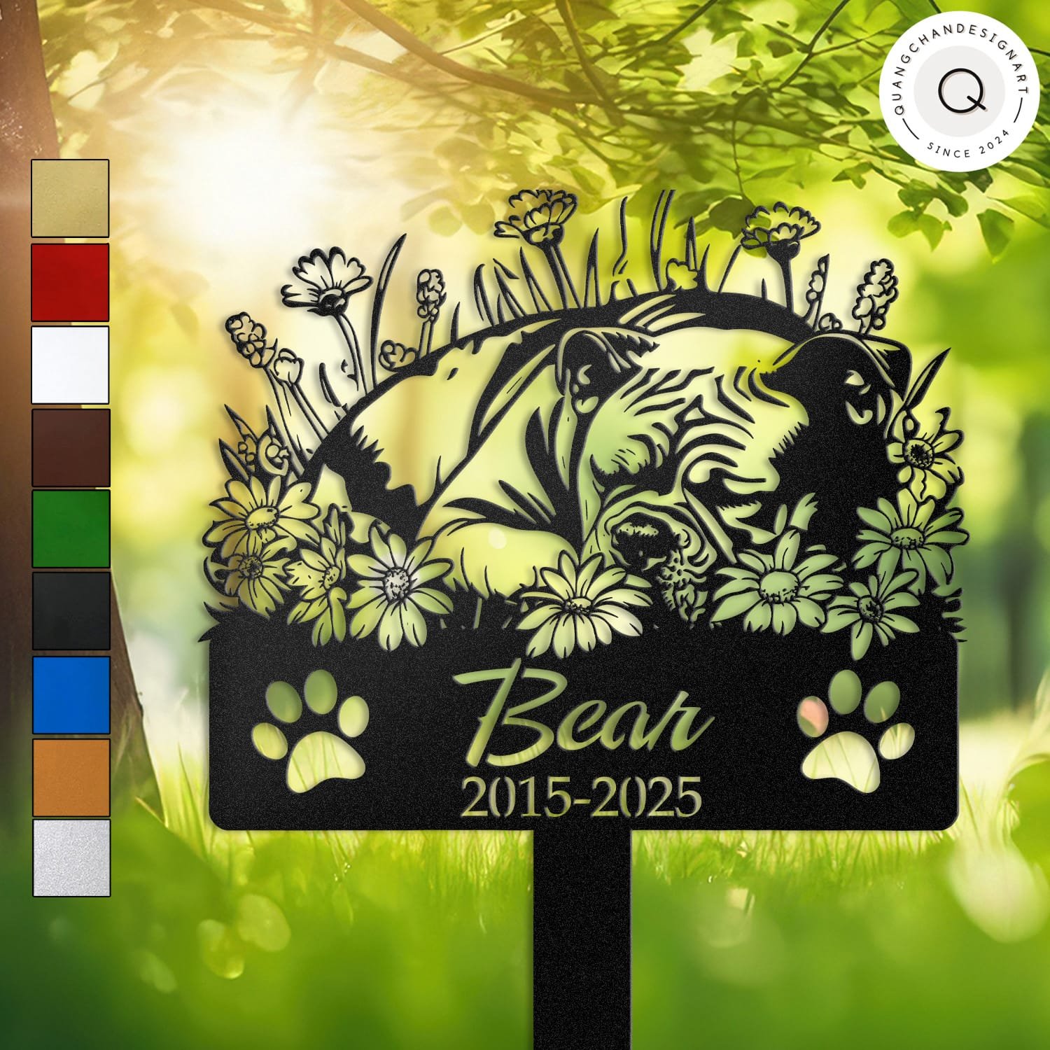 Personalized American Bully metal pet grave marker in a sleeping pose surrounded by daisy flowers, displayed in a sunlit garden with color swatch options
