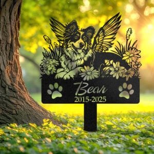 Personalized Australian Shepherd metal pet grave marker with angel wings and daisy flowers, displayed in a sunlit garden with color swatch options