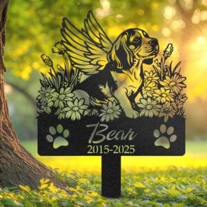 Personalized Beagle metal pet grave marker in a playful pose with angel wings and daisy flowers, displayed in a sunlit garden