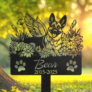 Personalized Belgian Malinois metal pet grave marker with angel wings and daisy flowers, displayed in a sunlit garden with color swatch options