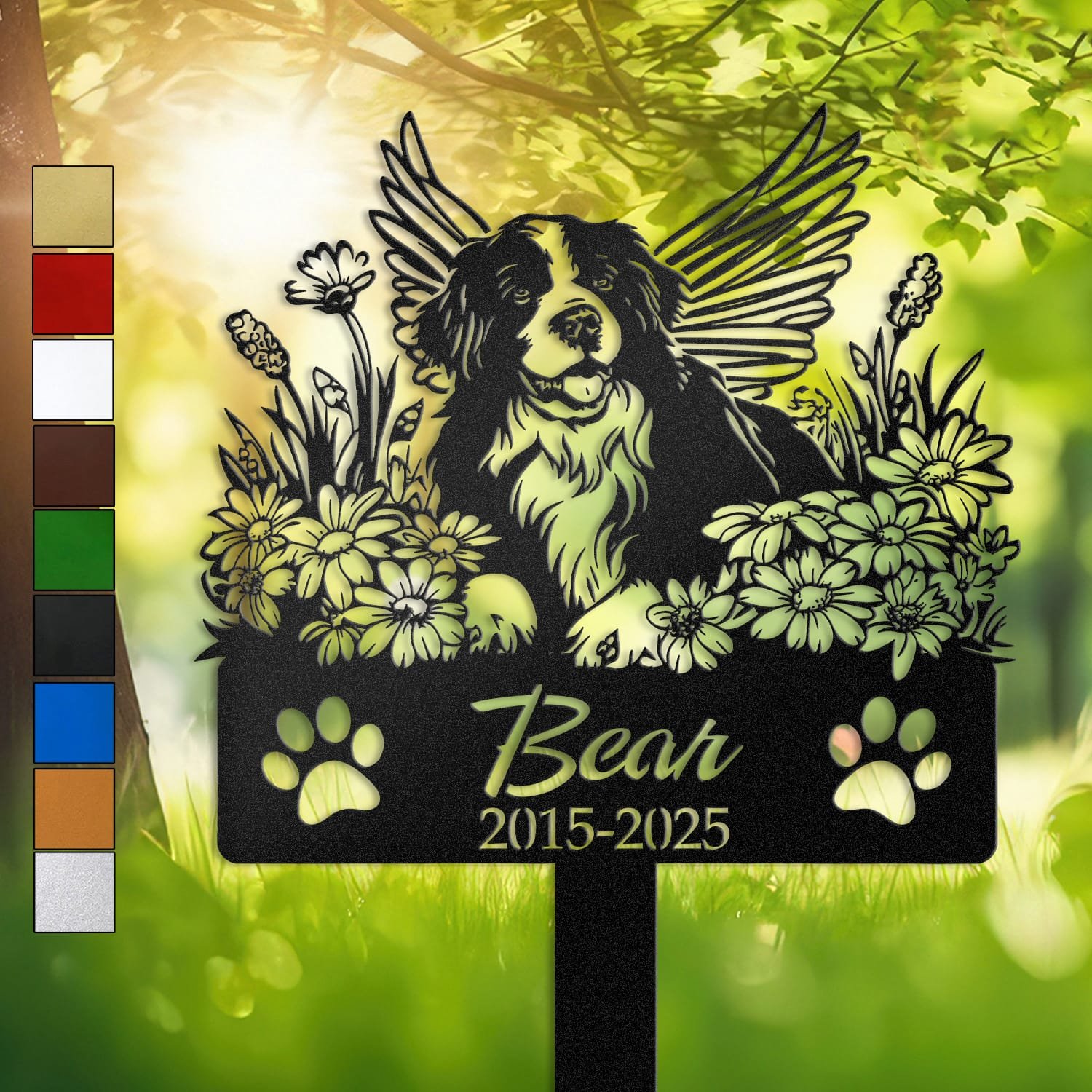 Personalized Bernese Mountain Dog metal pet grave marker with angel wings and daisy flowers, displayed in a sunlit garden with color swatch options