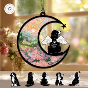 Crescent moon suncatcher with an angel-winged Bernese Mountain Dog silhouette beside a shooting star over a green sunrise landscape