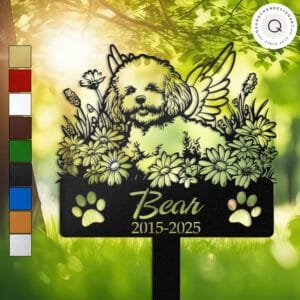 Personalized Bichon Frise metal pet grave marker with angel wings and daisy flowers, displayed in a sunlit garden with color swatch options