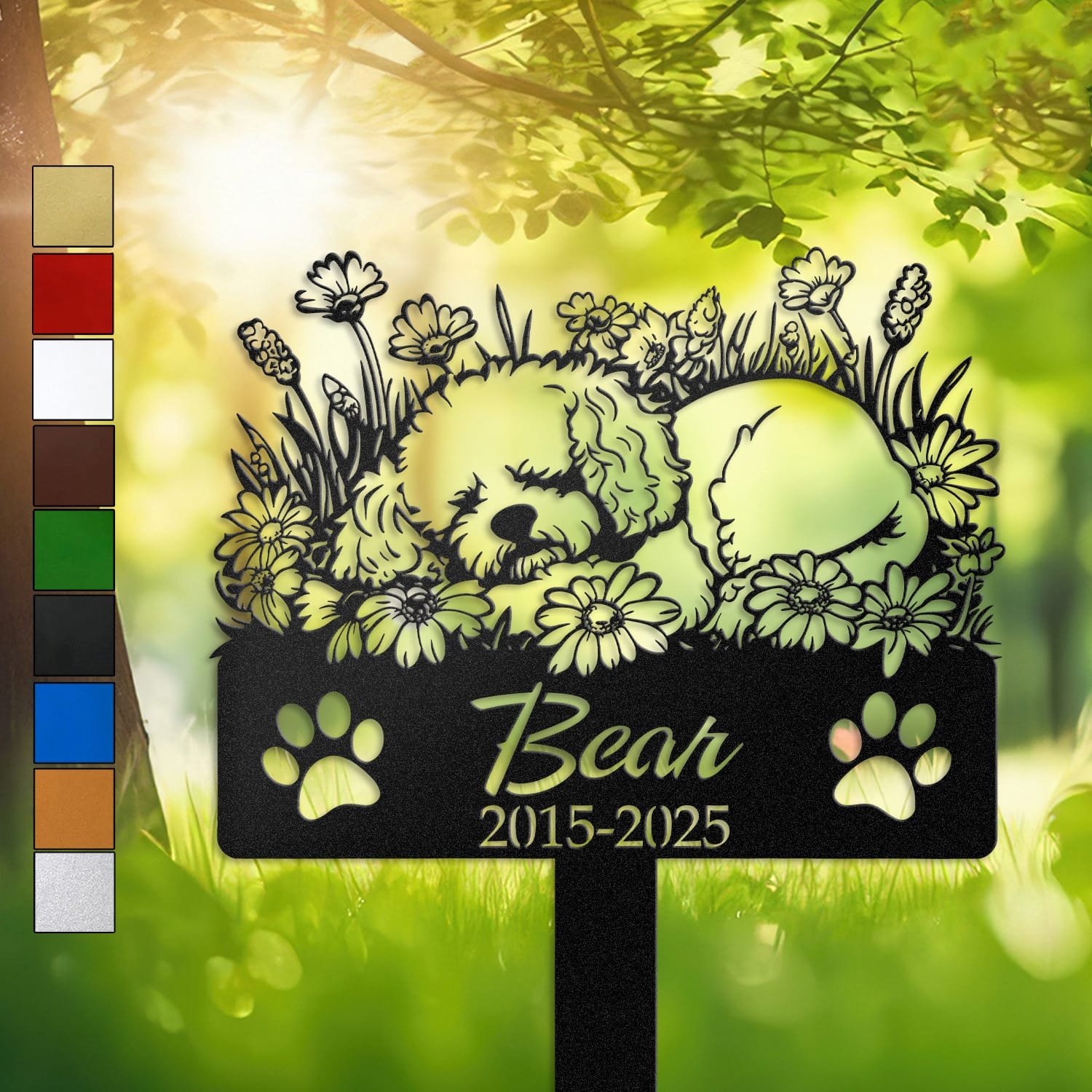 Personalized Bichon Frise metal pet grave marker in a sleeping pose surrounded by daisy flowers, displayed in a sunlit garden with color swatch options