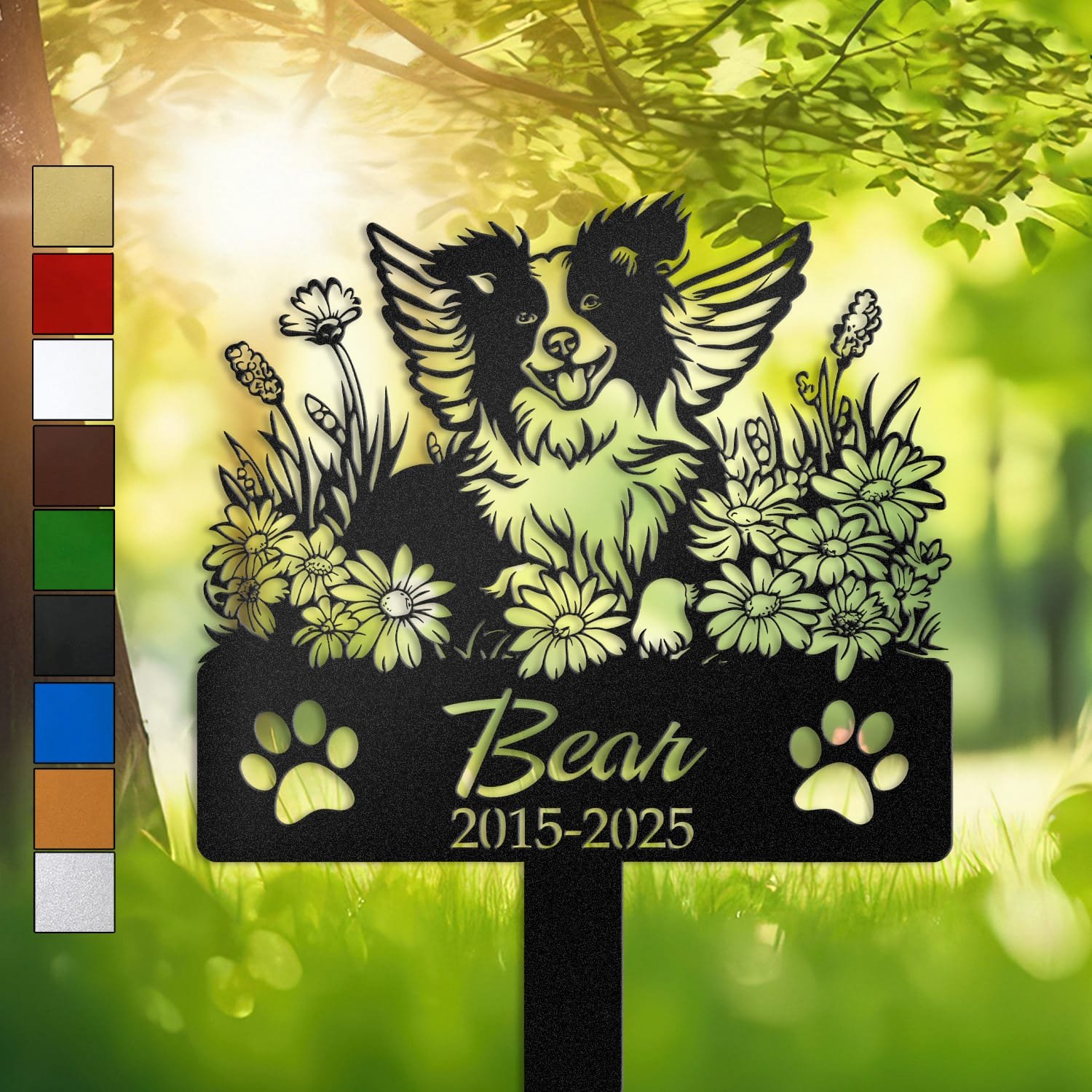 Personalized Border Collie metal pet grave marker with angel wings and daisy flowers, displayed in a sunlit garden with color swatch options