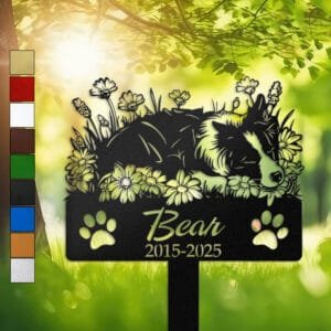 Personalized Border Collie metal pet grave marker in a sleeping pose surrounded by daisy flowers, displayed in a sunlit garden with color swatch options