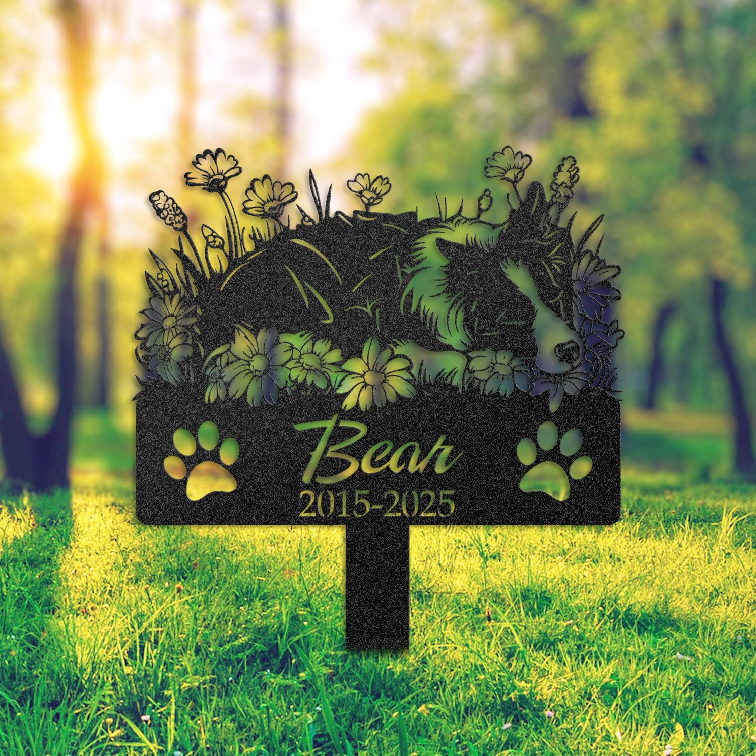 Border Collie pet grave marker placed in a rock garden bed in front of a brick house porch with an American flag