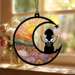 Crescent moon suncatcher with a curly-coated angel-winged Goldendoodle silhouette over a stained-glass dahlia field
