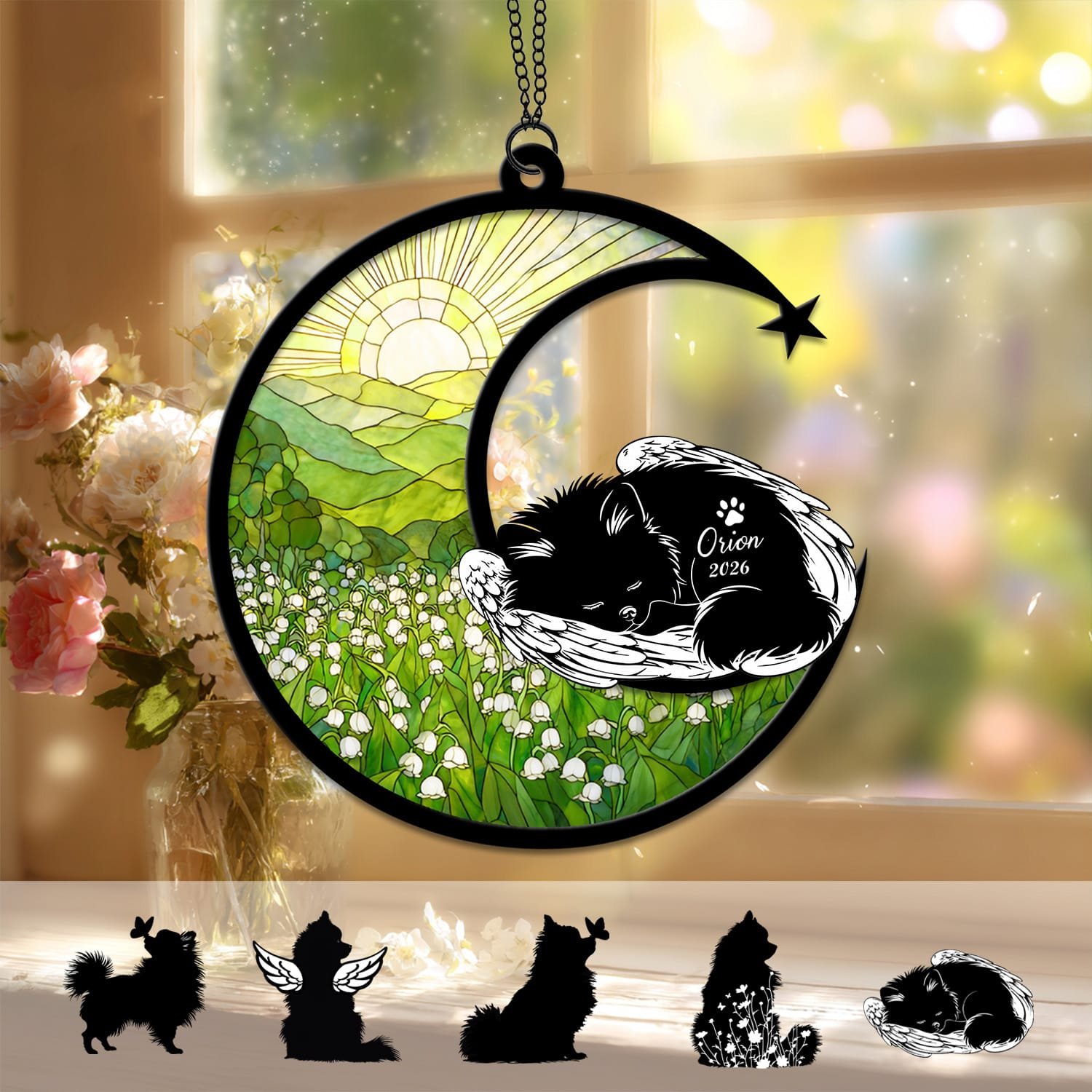 Crescent moon suncatcher with a sleeping angel-winged Pomeranian silhouette curled on the moon above a stained-glass lily of the valley field