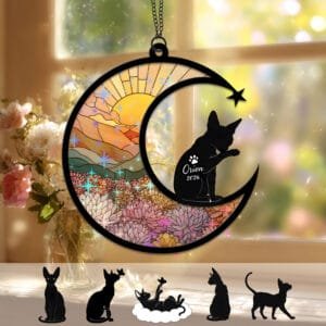 Crescent moon suncatcher with a large-eared Sphynx Cat silhouette and raised paw over a stained-glass autumn floral field