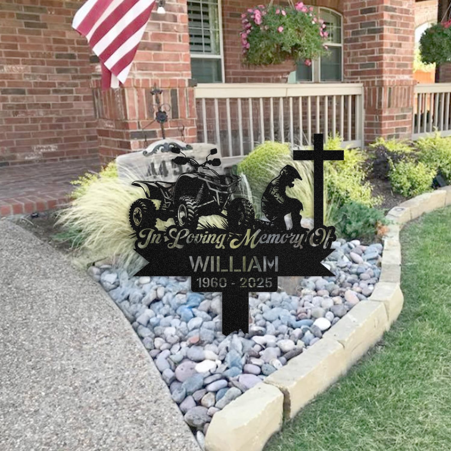 ATV human grave marker staged near a home entryway, showing the finished atv kneeling-at-the-cross design and name plate outdoors.
