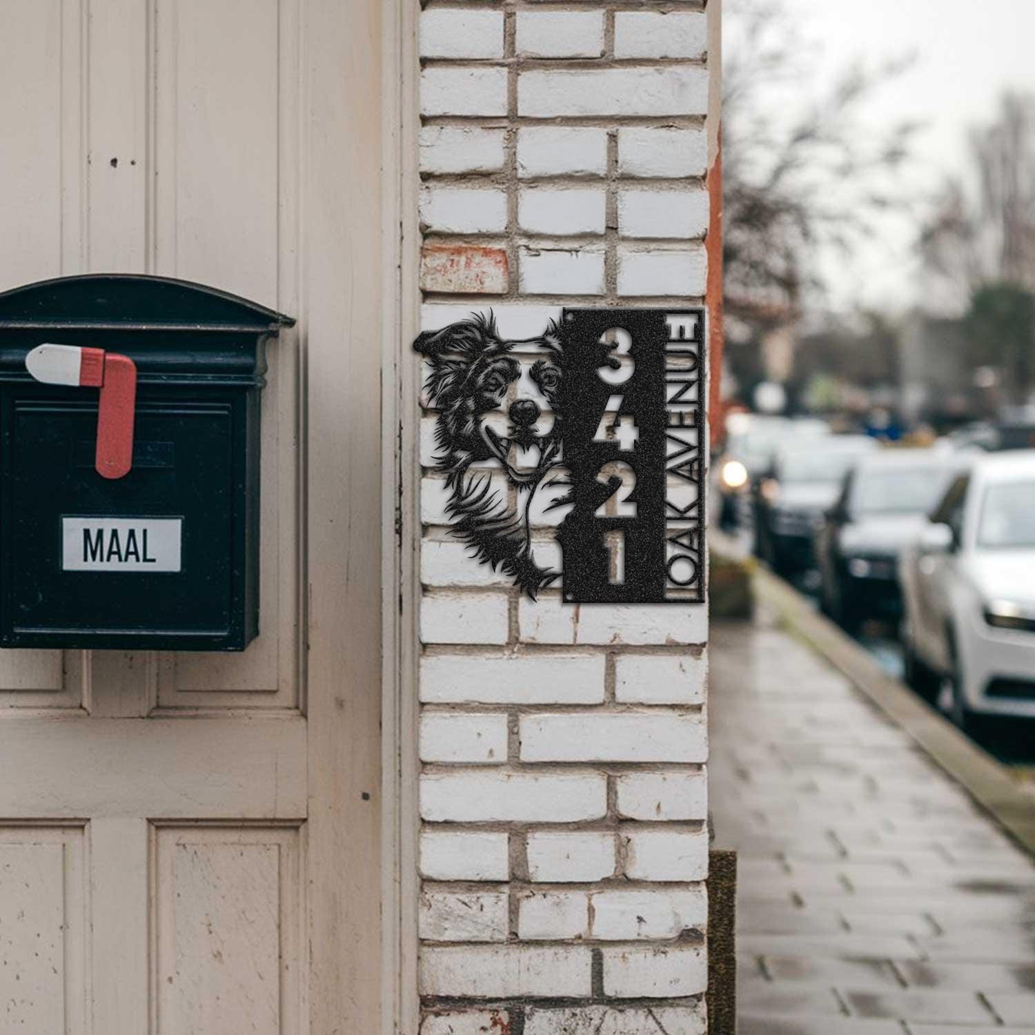 Border Collie address sign mounted on a brick pillar near a mailbox and front door