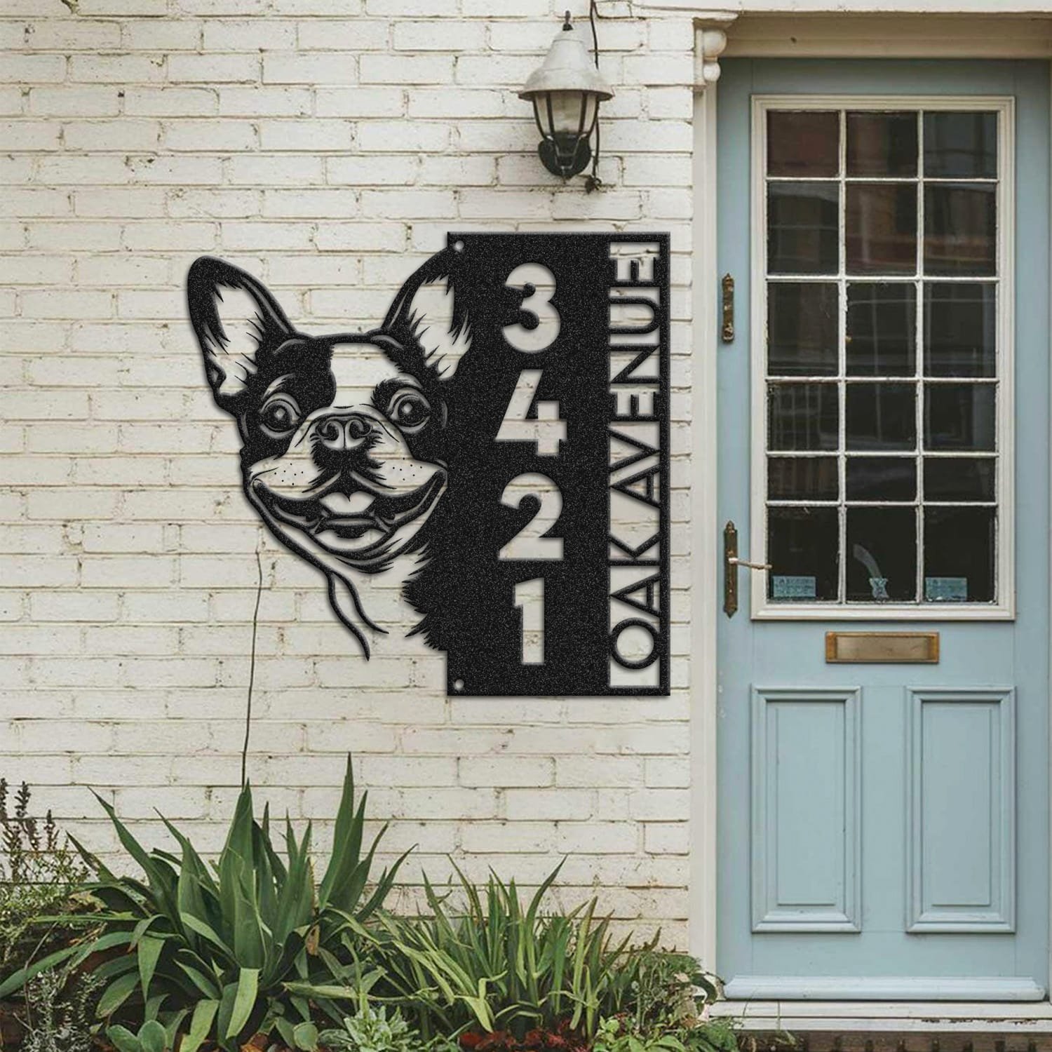 Boston Terrier bandana address sign mounted on a painted brick wall beside a wooden front door