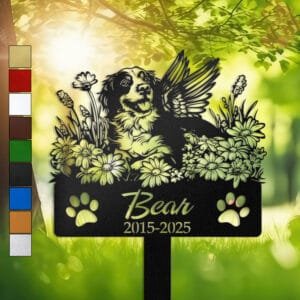 Personalized Brittany Spaniel metal pet grave marker with angel wings and daisy flowers, displayed in a sunlit garden with color swatch options