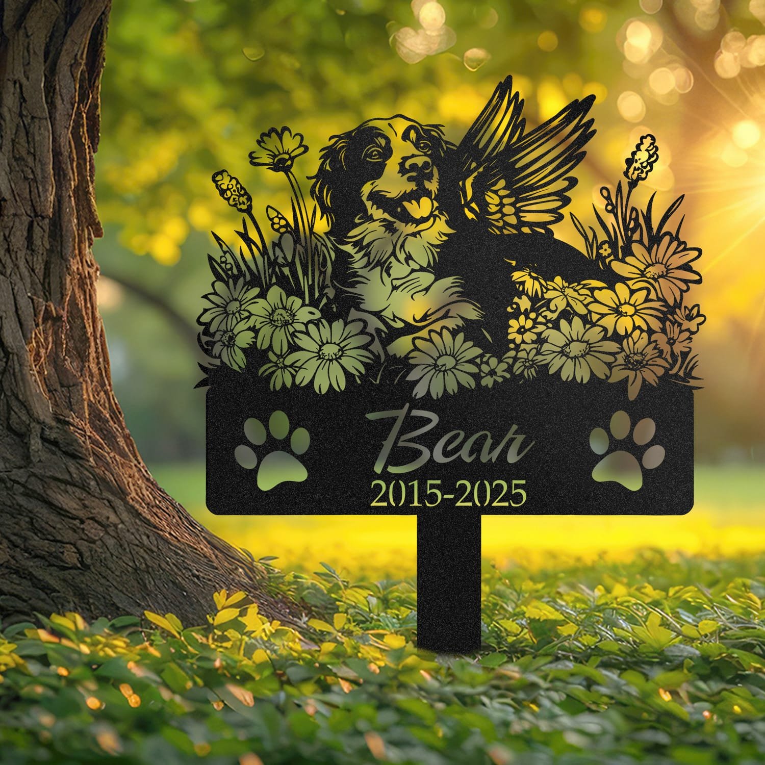 Brittany Spaniel angel wings pet grave marker staked into the ground beside a large tree trunk in a garden setting