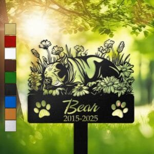 Personalized Bull Terrier metal pet grave marker in a sleeping pose surrounded by daisy flowers, displayed in a sunlit garden with color swatch options