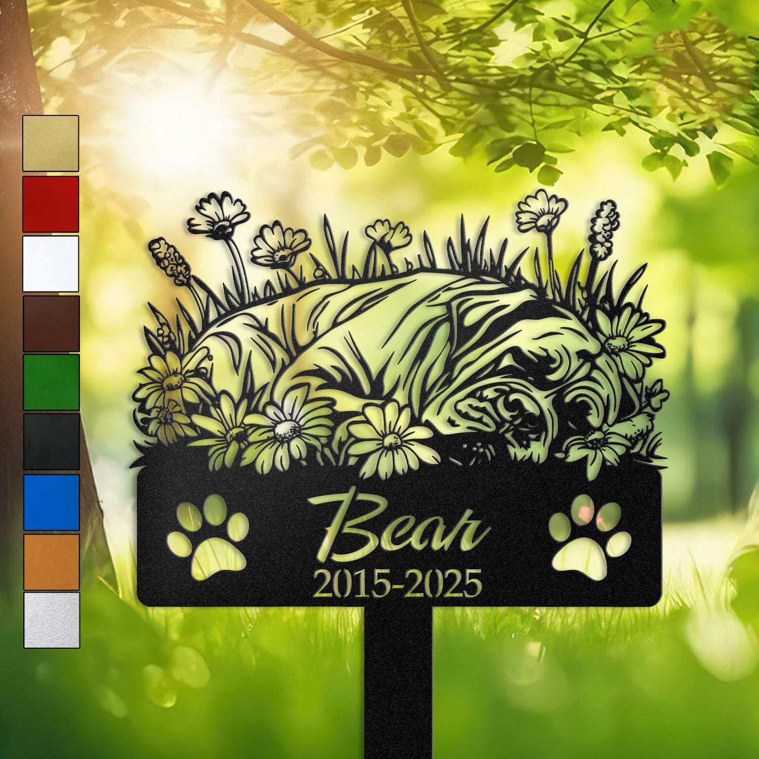 Personalized Cane Corso metal pet grave marker in a sleeping pose surrounded by daisy flowers, displayed in a sunlit garden with color swatch options