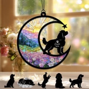 Crescent moon suncatcher with a feathery-eared Cavalier King Charles Spaniel silhouette over a stained-glass purple daisy field