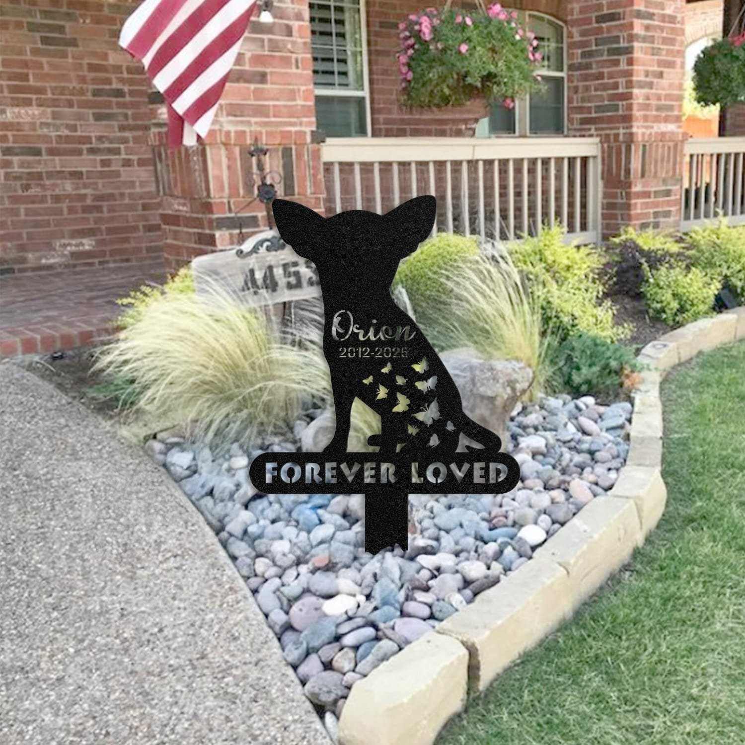 Chihuahua pet grave marker staged near a home entryway, showing the finished butterfly silhouette design with the 'Forever Loved' engraving and name plate outdoors.