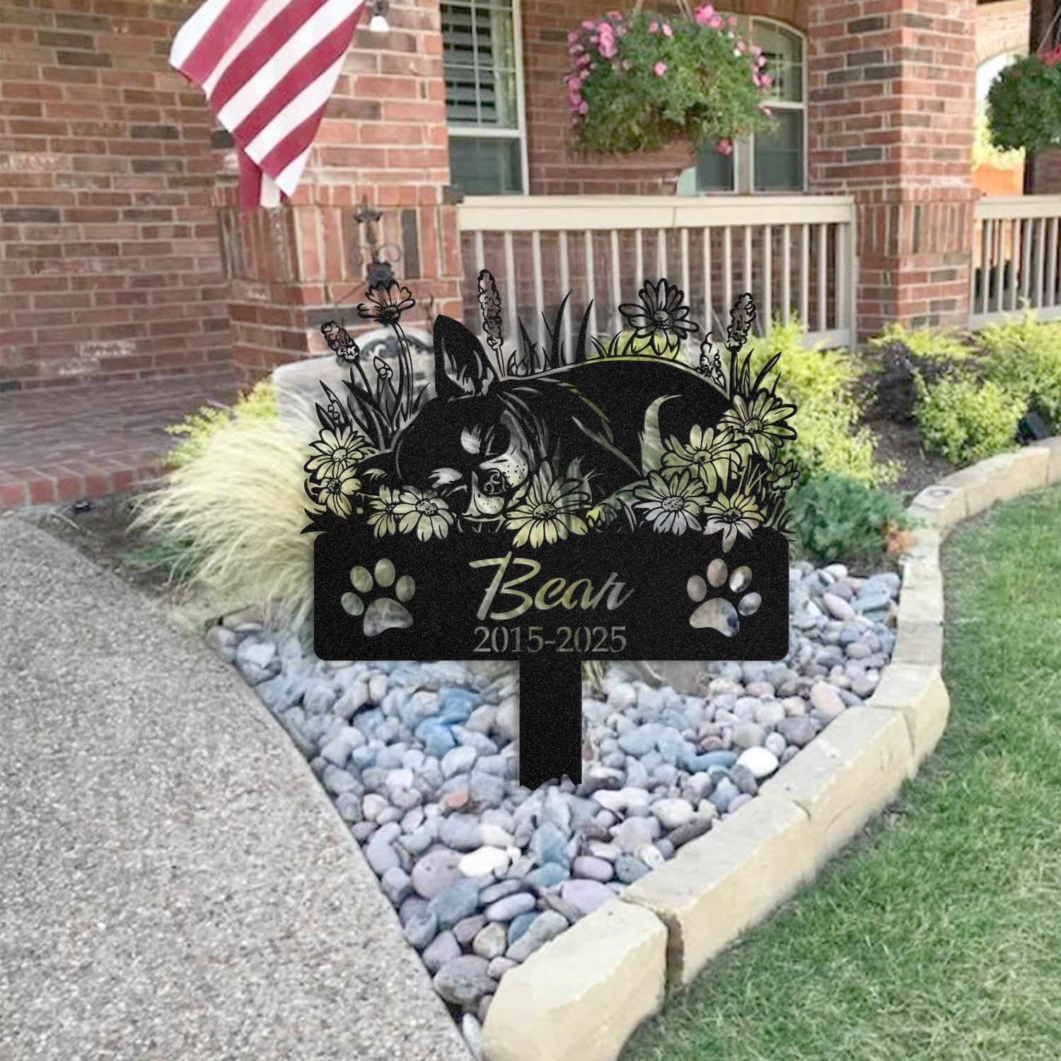 Chihuahua pet grave marker staged near a home entryway, showing the finished sleeping-pose daisy floral design and name plate outdoors.