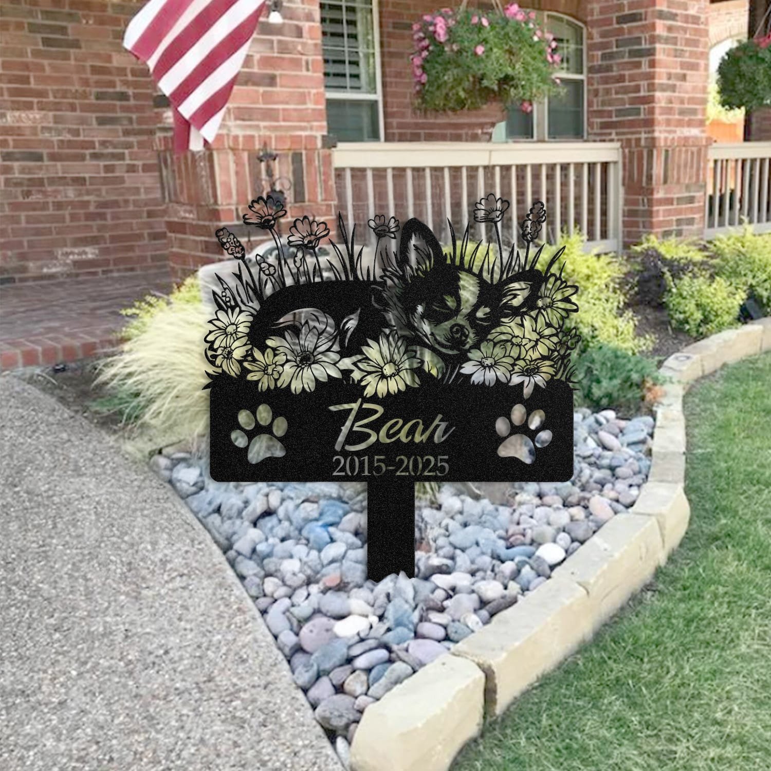 Chihuahua pet grave marker staged near a home entryway, showing the finished sleeping-pose daisy floral design and name plate outdoors.