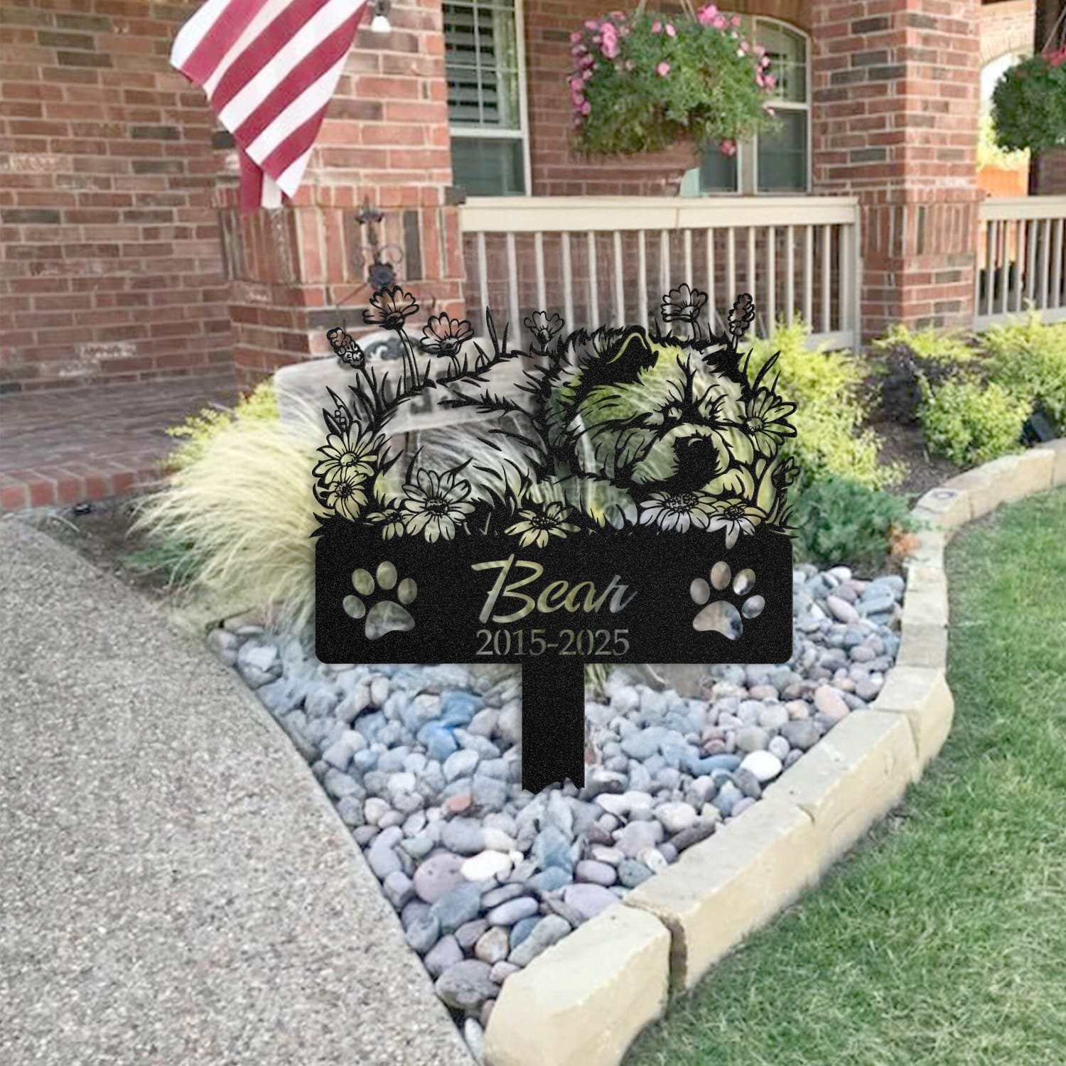 Chow Chow sleeping pose pet grave marker staked into the ground beside a large tree trunk in a garden setting