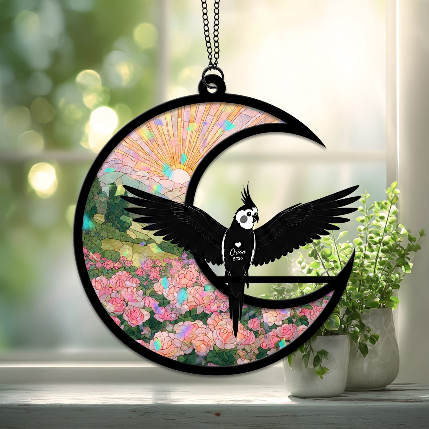 Broken Glass style suncatcher featuring a Cockatiel silhouette on a crescent moon with a cracked-glass style sunrise and floral background