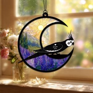 Crescent moon suncatcher with a crested Cockatiel silhouette perched on the moon over a stained-glass purple lupine field