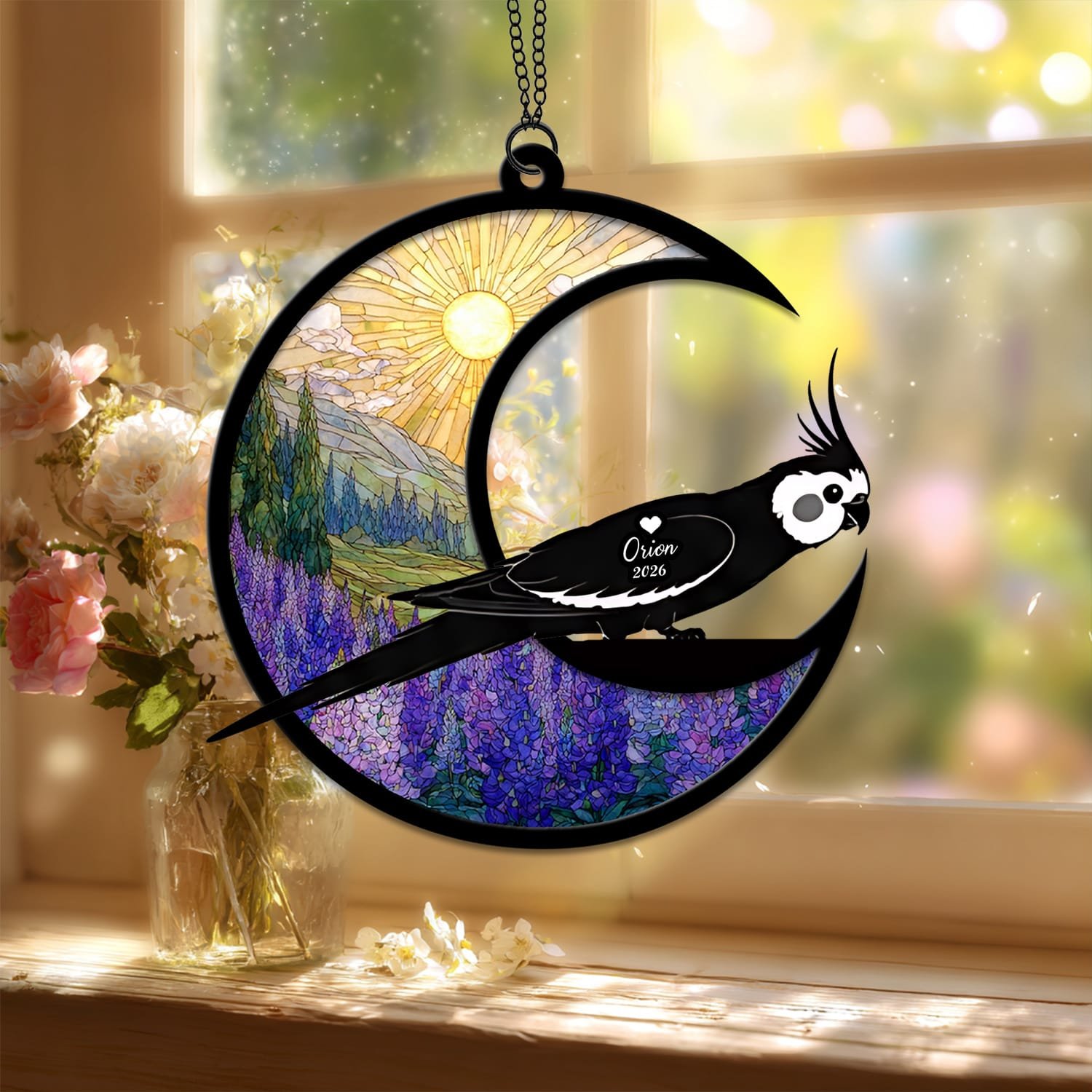 Crescent moon suncatcher with a crested Cockatiel silhouette perched on the moon over a stained-glass purple lupine field