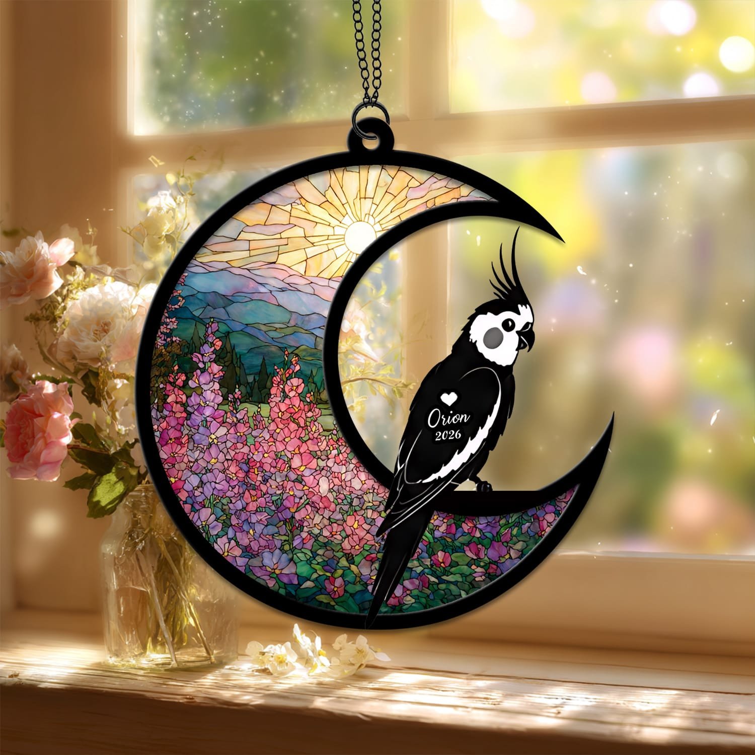 Standard style suncatcher featuring a Cockatiel silhouette on a crescent moon with a stained-glass sunrise and floral background