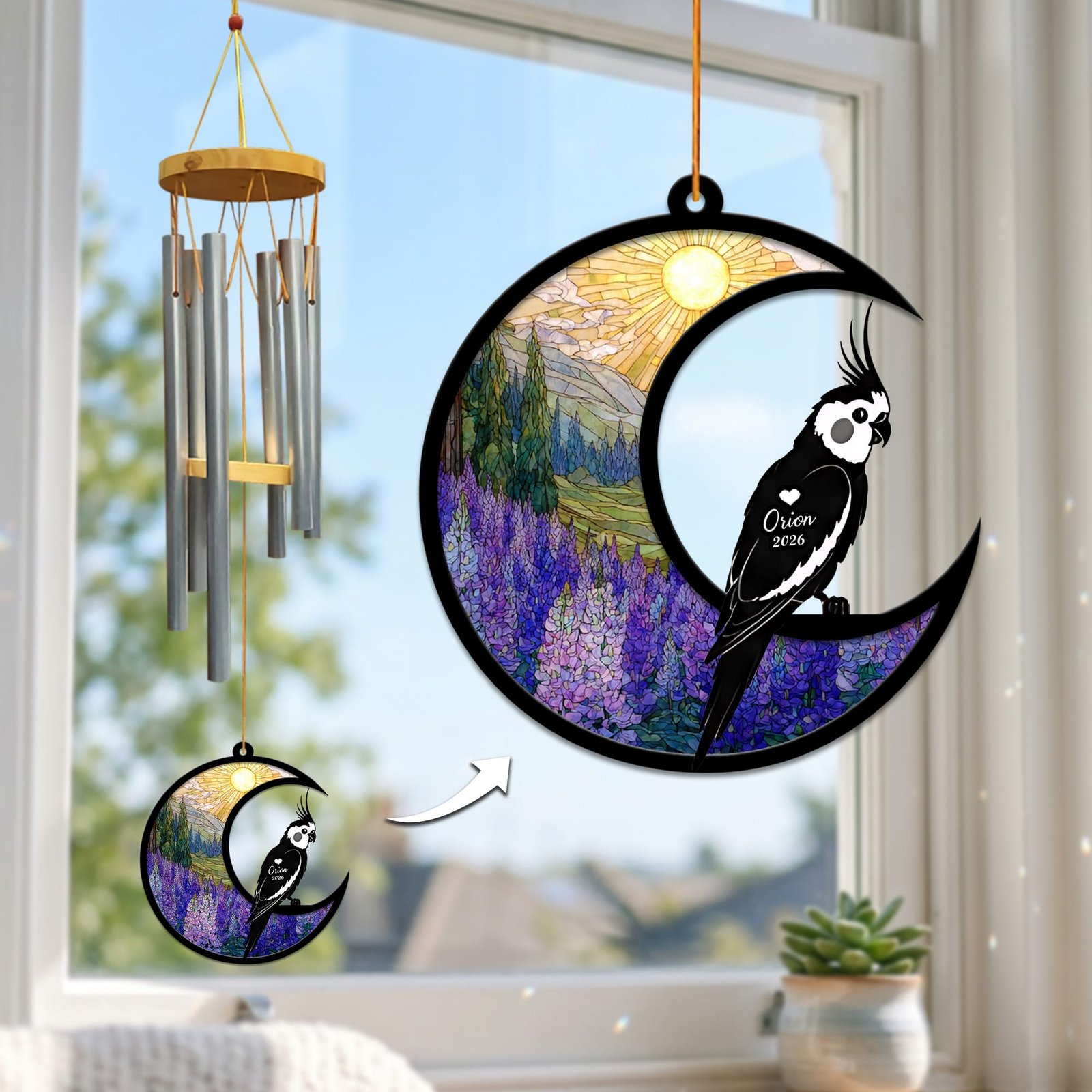 Stained-glass memorial wind chime suncatcher showing a cockatiel silhouette perched on a crescent moon over a purple lupine field, hanging in a sunny window