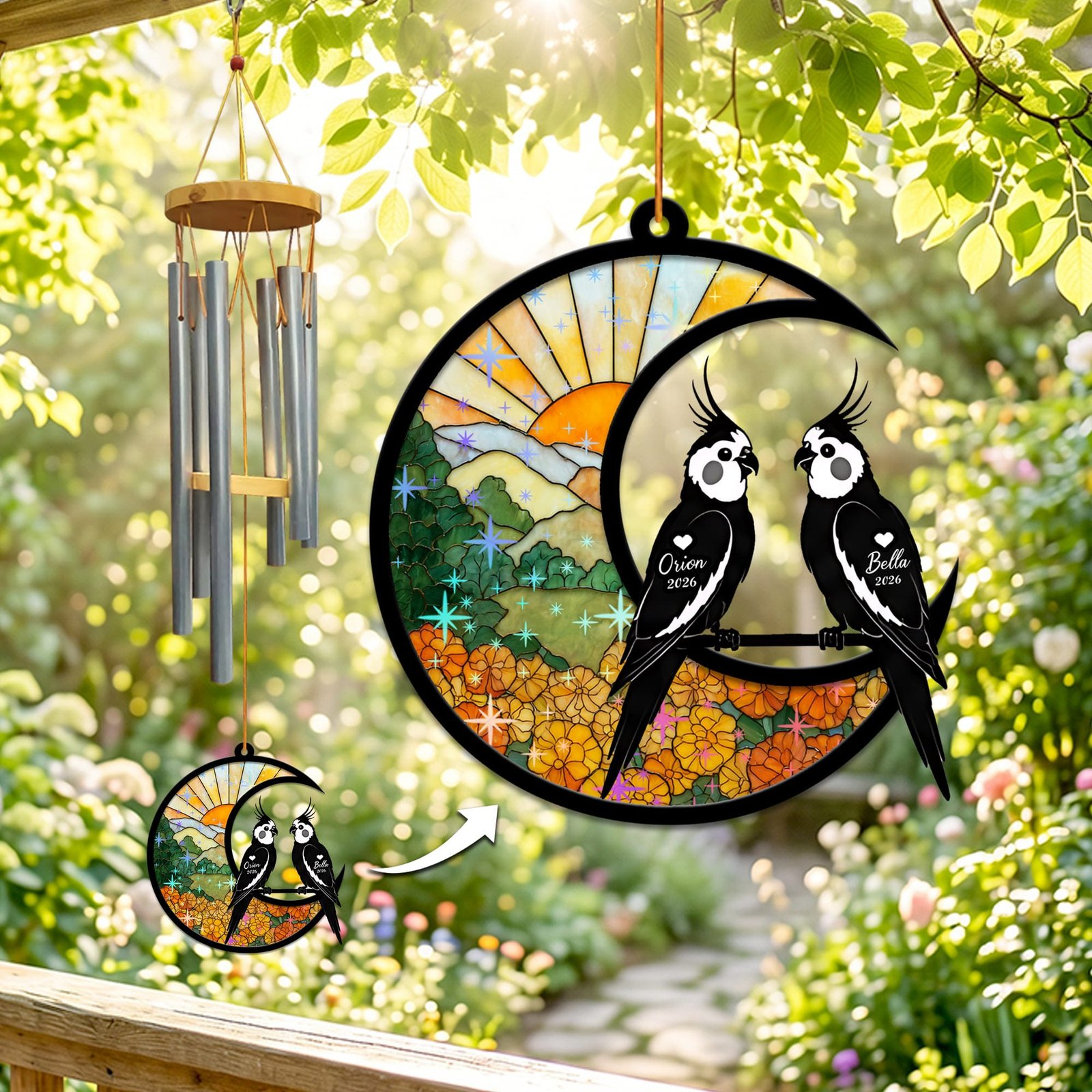 Stained-glass memorial wind chime suncatcher showing two cockatiels perched together on a crescent moon over marigolds with sparkling star accents