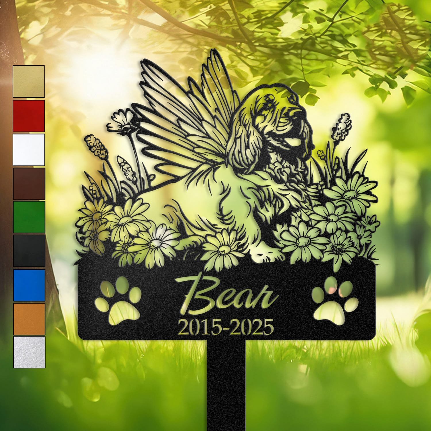 Personalized Cocker Spaniel metal pet grave marker with angel wings and daisy flowers, displayed in a sunlit garden with color swatch options