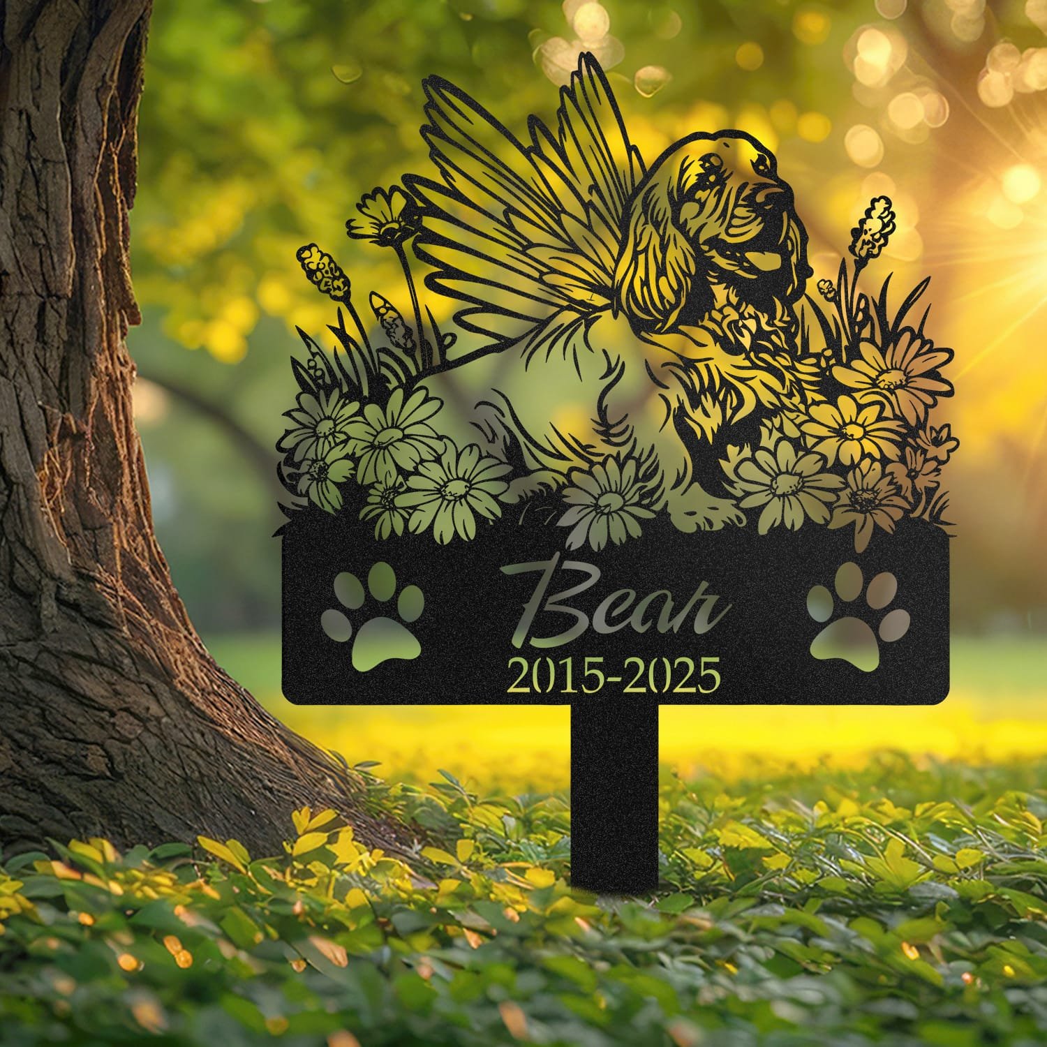 Cocker Spaniel angel wings pet grave marker shown close up in a sunlit garden with daisy flowers and grass