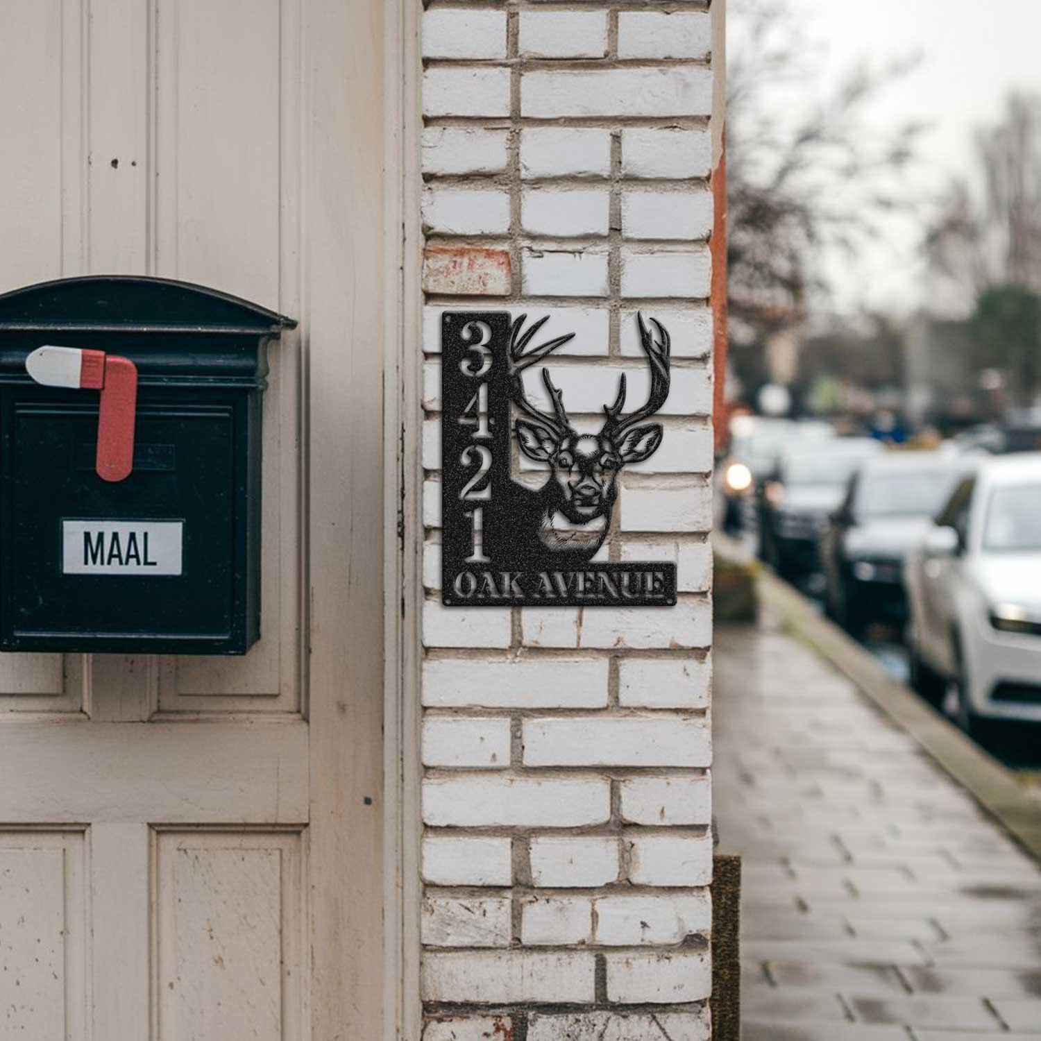 Deer address sign mounted on a brick pillar near a mailbox and front door