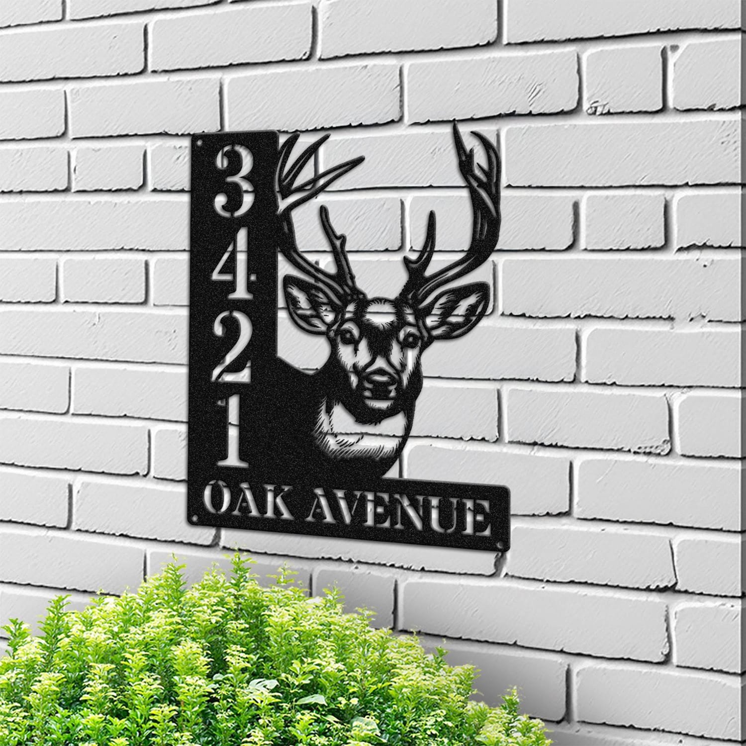 Deer address sign mounted on a light brick wall in a street-facing view