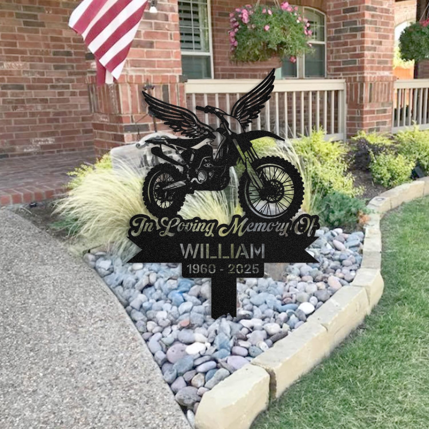 Dirt Bike human grave marker staged near a home entryway, showing the finished dirt bike angel wings design and name plate outdoors.