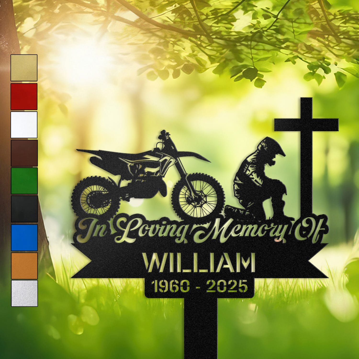 Dirt Bike human grave marker displayed outdoors in a garden setting, showing the personalized dirt bike kneeling-at-the-cross design in place on the stake.