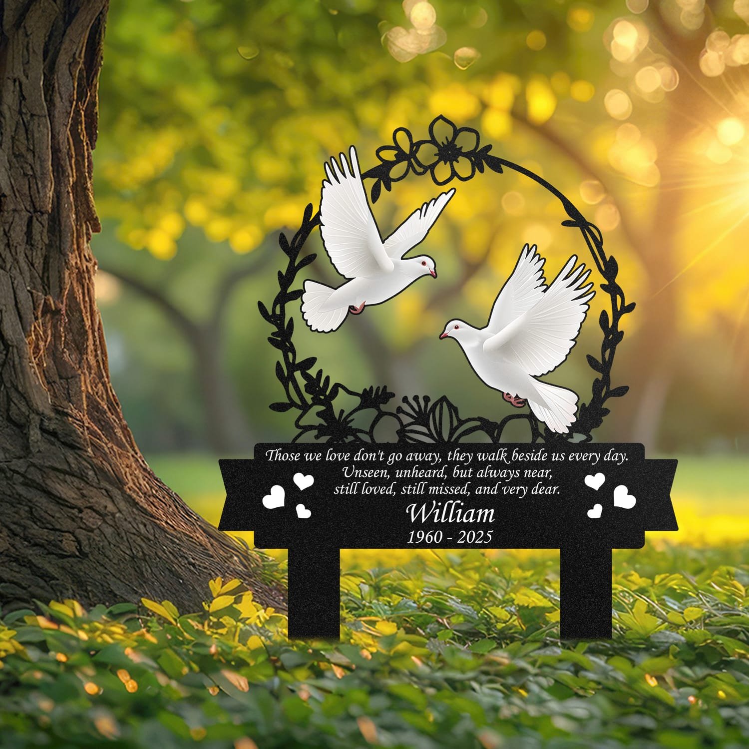 Dove human grave marker displayed outdoors in a garden setting, showing the personalized floral wreath bird-pair design in place on the stake.