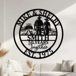 Metal wall art design of a farmer couple walking hand in hand away from the viewer through a field, with a tractor in the background, set within a circular frame reading the couple's names at the top and their last name, years together, and established year at the bottom, fully personalizable.