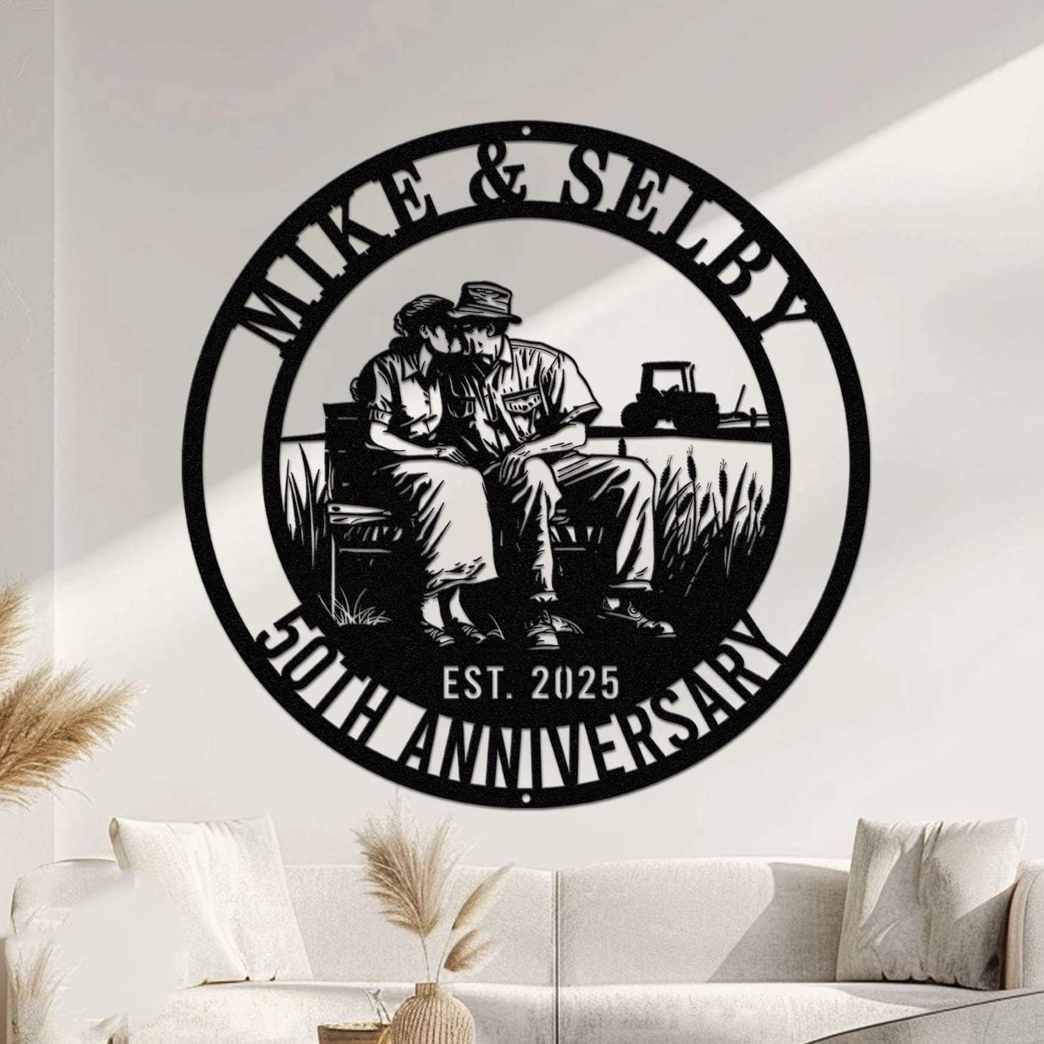 Metal wall art design of a farmer couple sitting close together on a bench in a tender embrace, with a tractor in the background, set within a circular frame reading the couple's names at the top and 'Anniversary' with the established year at the bottom, fully personalizable.