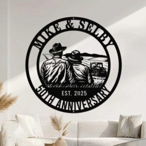 Metal wall art design of a farmer couple sitting together on a bench with their backs to the viewer, overlooking a field and distant hills, with a tractor in the background, set within a circular frame reading the couple's names at the top and 'Anniversary' with the established year at the bottom, fully personalizable.