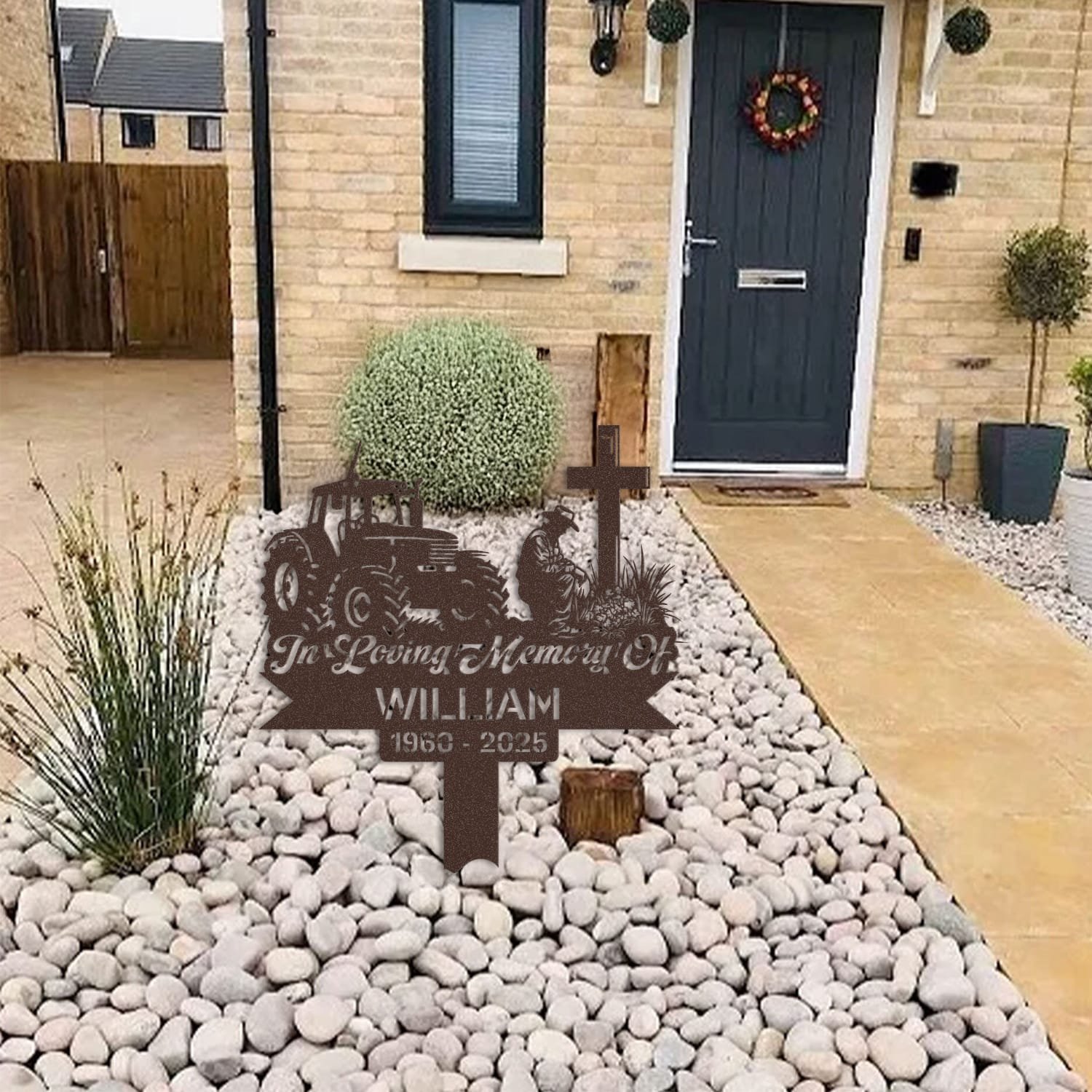 Farmer human grave marker displayed among garden plants and stone edging, showing the design as an outdoor memorial accent.