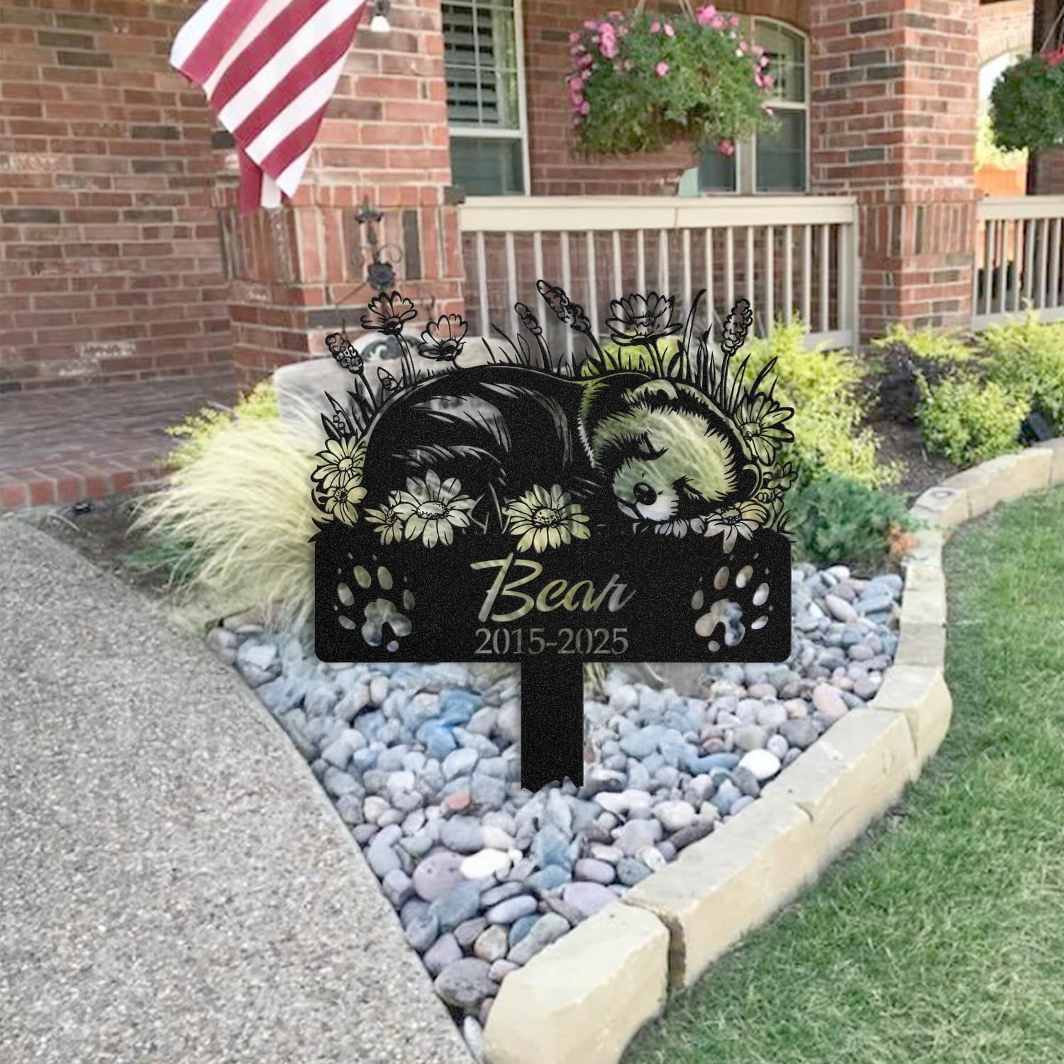 Ferret pet grave marker staged near a home entryway, showing the finished sleeping-pose daisy floral design and name plate outdoors.
