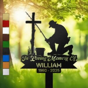 Metal memorial design of a fisherman kneeling at a wooden cross with his fishing rod and tackle bucket beside him, engraved with 'In Loving Memory Of', personalized with a name and memorial years.