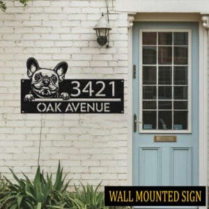 Personalized French Bulldog address sign attached flush to a brick wall beside a blue front door, reading 3421 Oak Avenue
