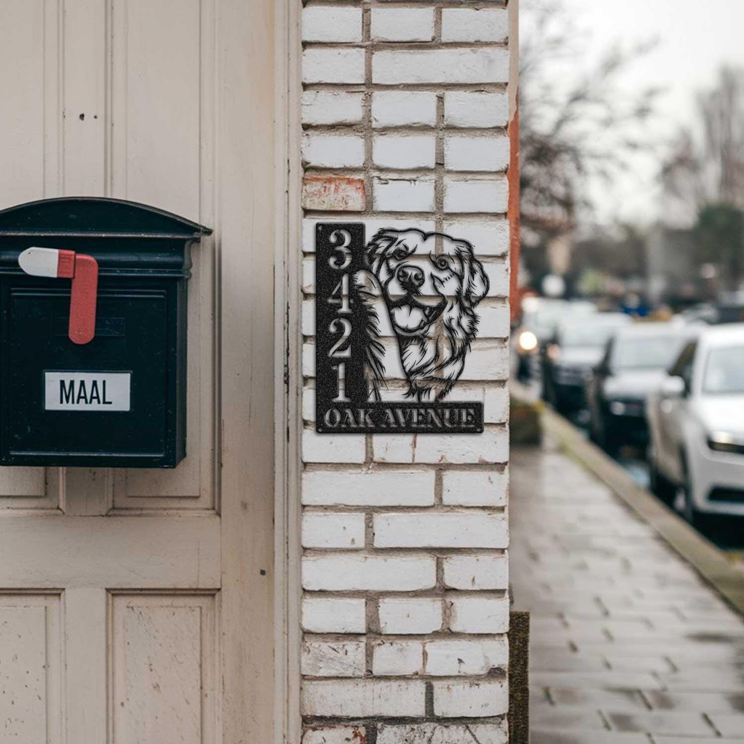 Golden Retriever address sign mounted on a brick pillar near a mailbox and front door