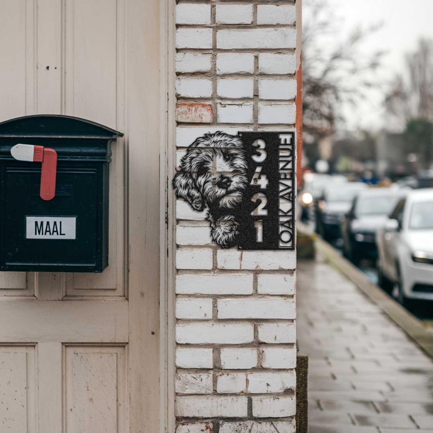 Goldendoodle address sign mounted on a brick pillar near a mailbox and front door