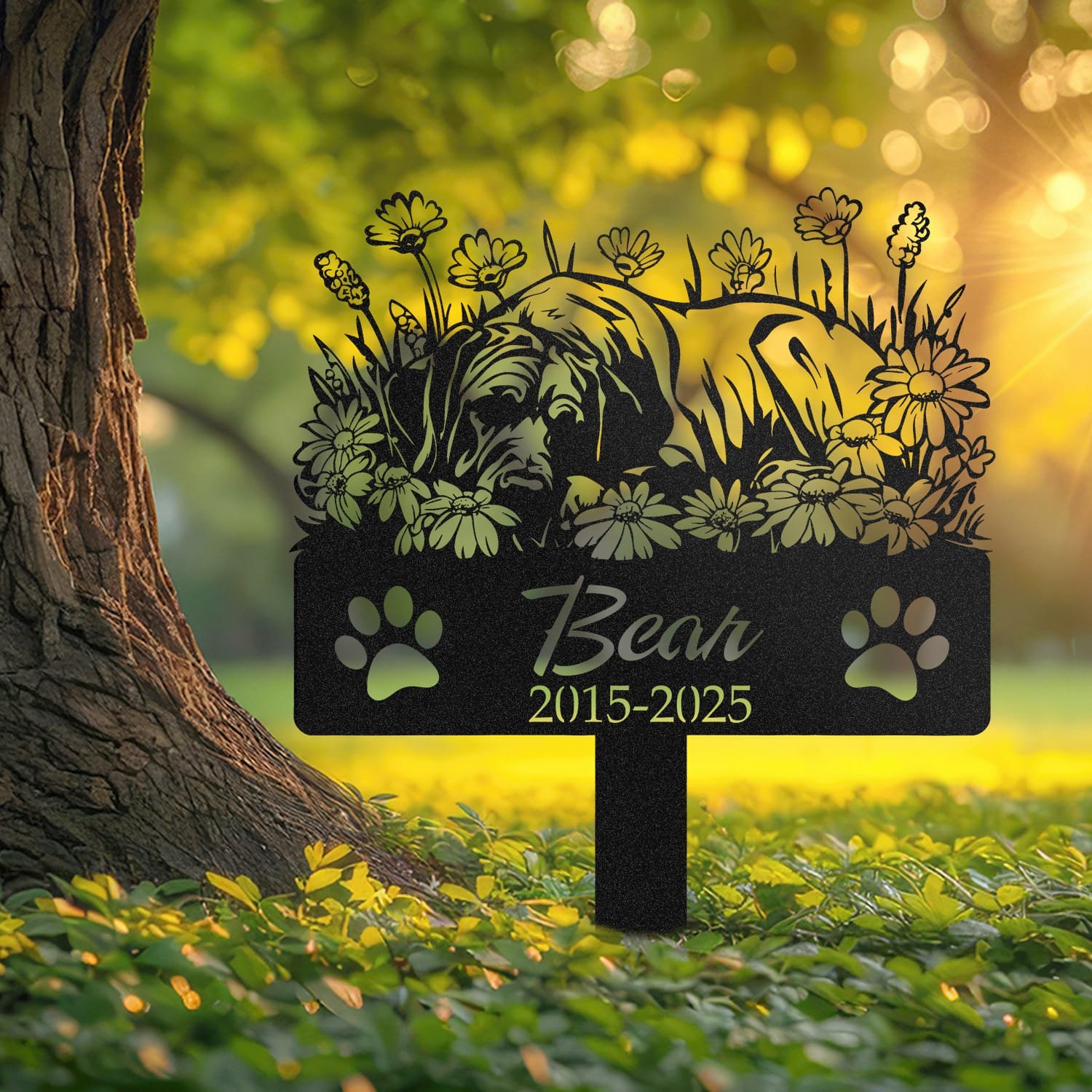 Great Dane sleeping pose pet grave marker staked into the ground beside a large tree trunk in a garden setting