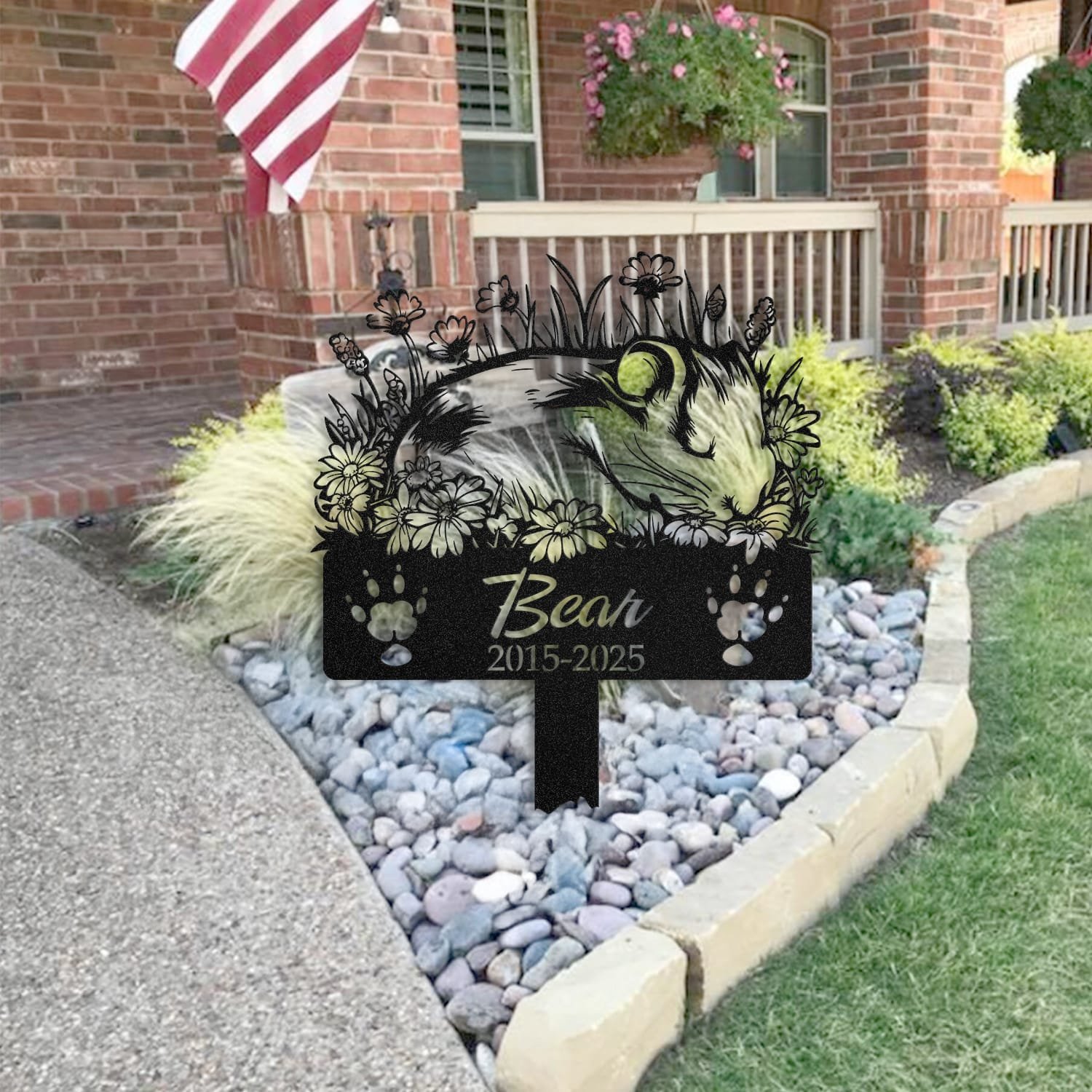 Guinea Pig pet grave marker staged near a home entryway, showing the finished sleeping-pose daisy floral design and name plate outdoors.